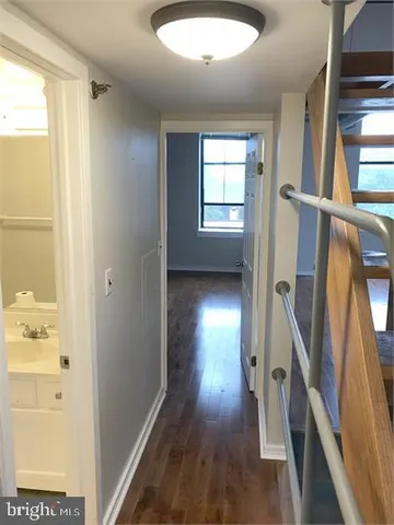 a view of entryway with wooden floor and stairs