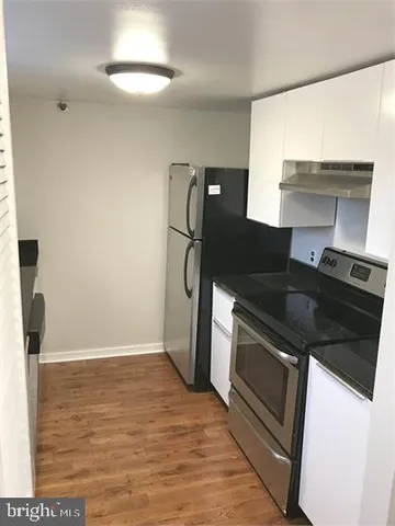 a kitchen with a sink and a refrigerator