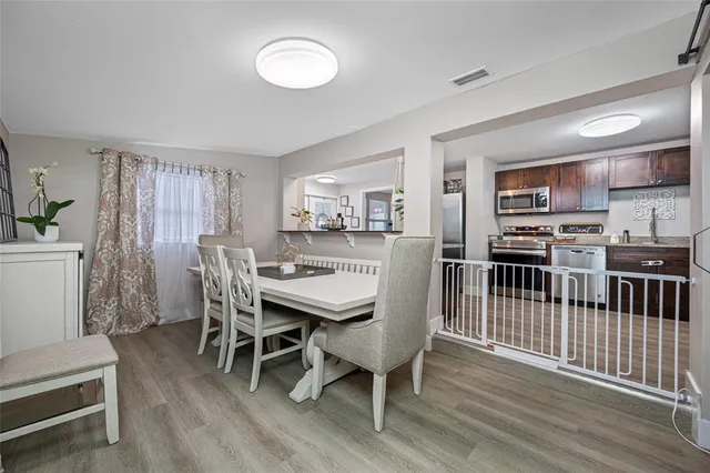 a view of a dining room with furniture window and wooden floor