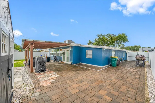 a view of a house with backyard and sitting area