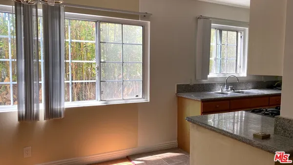 a view of a kitchen area with furniture and windows