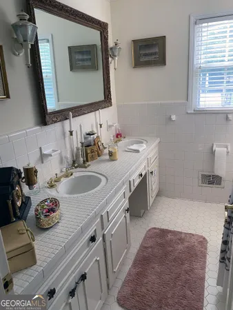 a living room with furniture a chandelier and a fireplace
