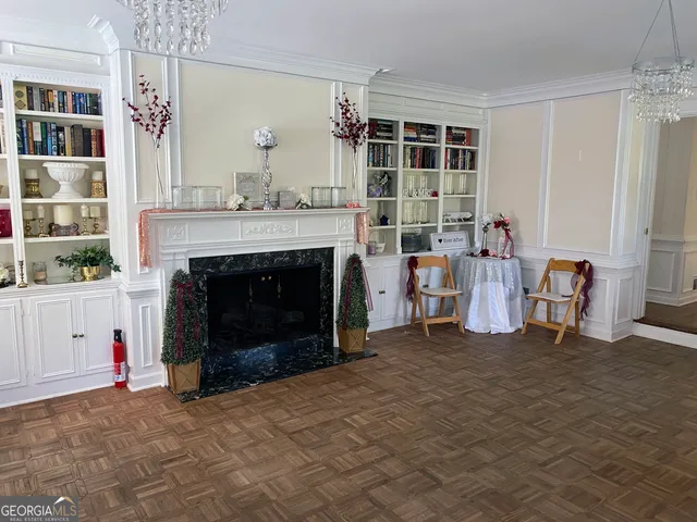 a view of a swimming pool with a table and chairs under an umbrella