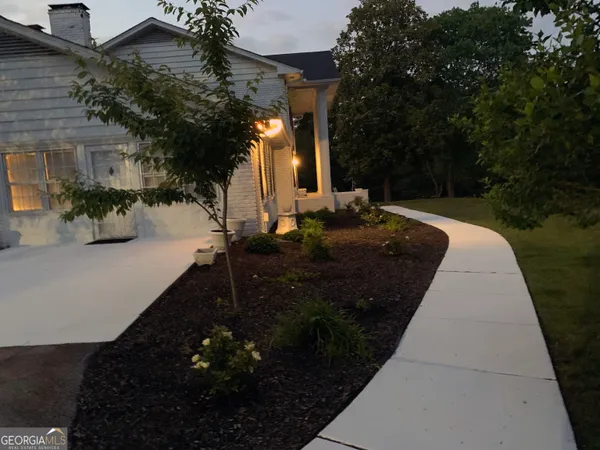 a view of a patio with a table and chairs under an umbrella