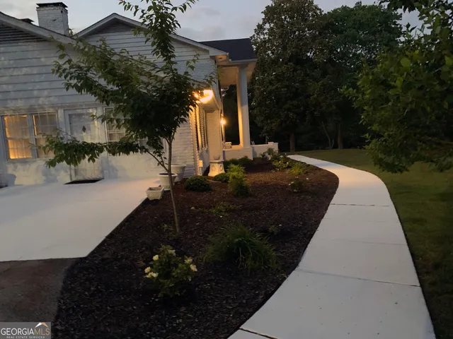 a view of a patio with a table and chairs under an umbrella