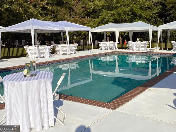 a view of a patio with table and chairs and potted plants