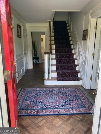 a view of a livingroom with wooden floor and a window