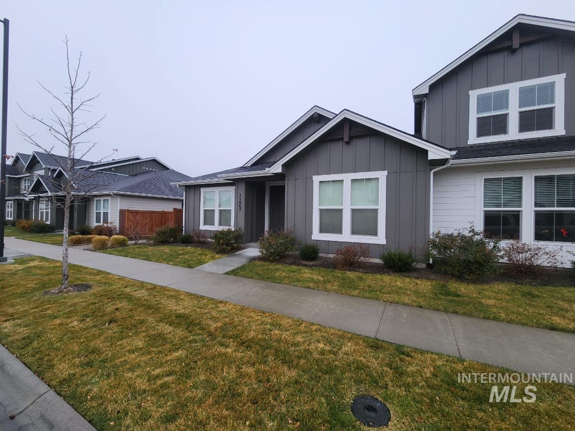 11067 West Shelborne Street Boise, ID 83709 - Photo 1 of 31 View of front of property with board and batten siding and a front lawn