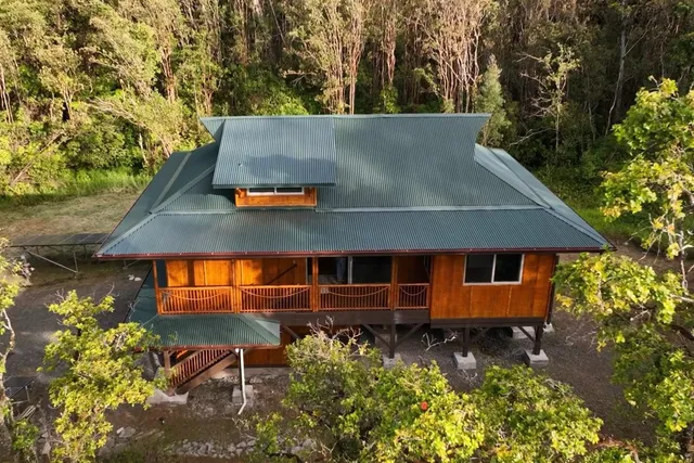 an aerial view of a house with a yard
