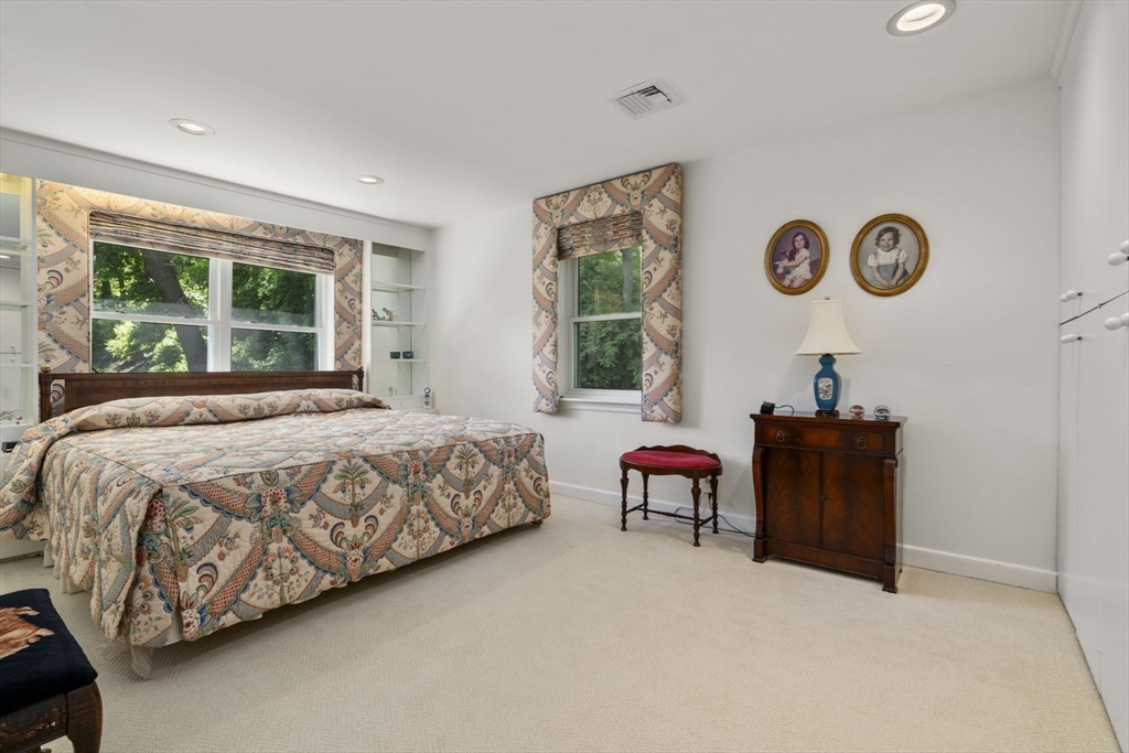127-129 Withington Road Newton, MA 02460 - Photo 16 of 33 a bedroom with a bed and a chair