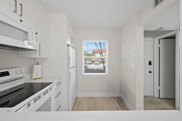 a view of a hallway with washer and dryer