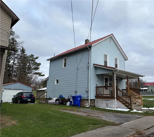 a view of a house with a yard and sitting area