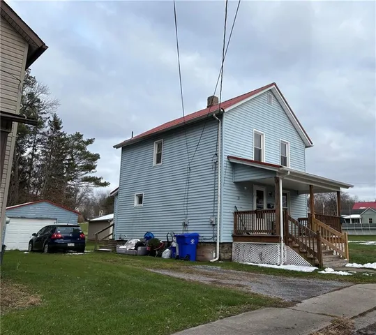 a view of a house with a yard and sitting area