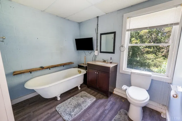 a bathroom with a toilet sink a mirror and bathtub