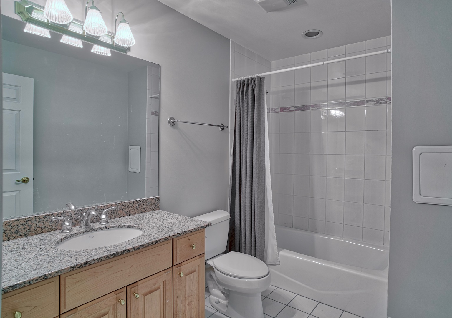 1830 Telegraph Road Lake Forest, IL 60045 - Photo 24 of 31 a bathroom with a granite countertop sink a toilet and shower