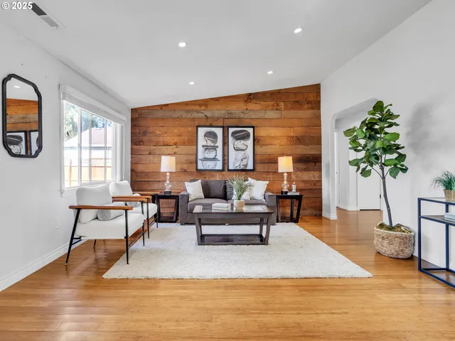 a living room with furniture and a potted plant