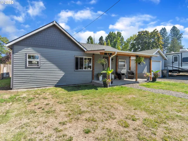a bedroom with a bed and a lamp on dresser