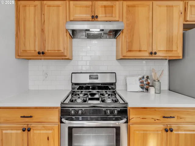 a kitchen with stainless steel appliances granite countertop a stove and a microwave