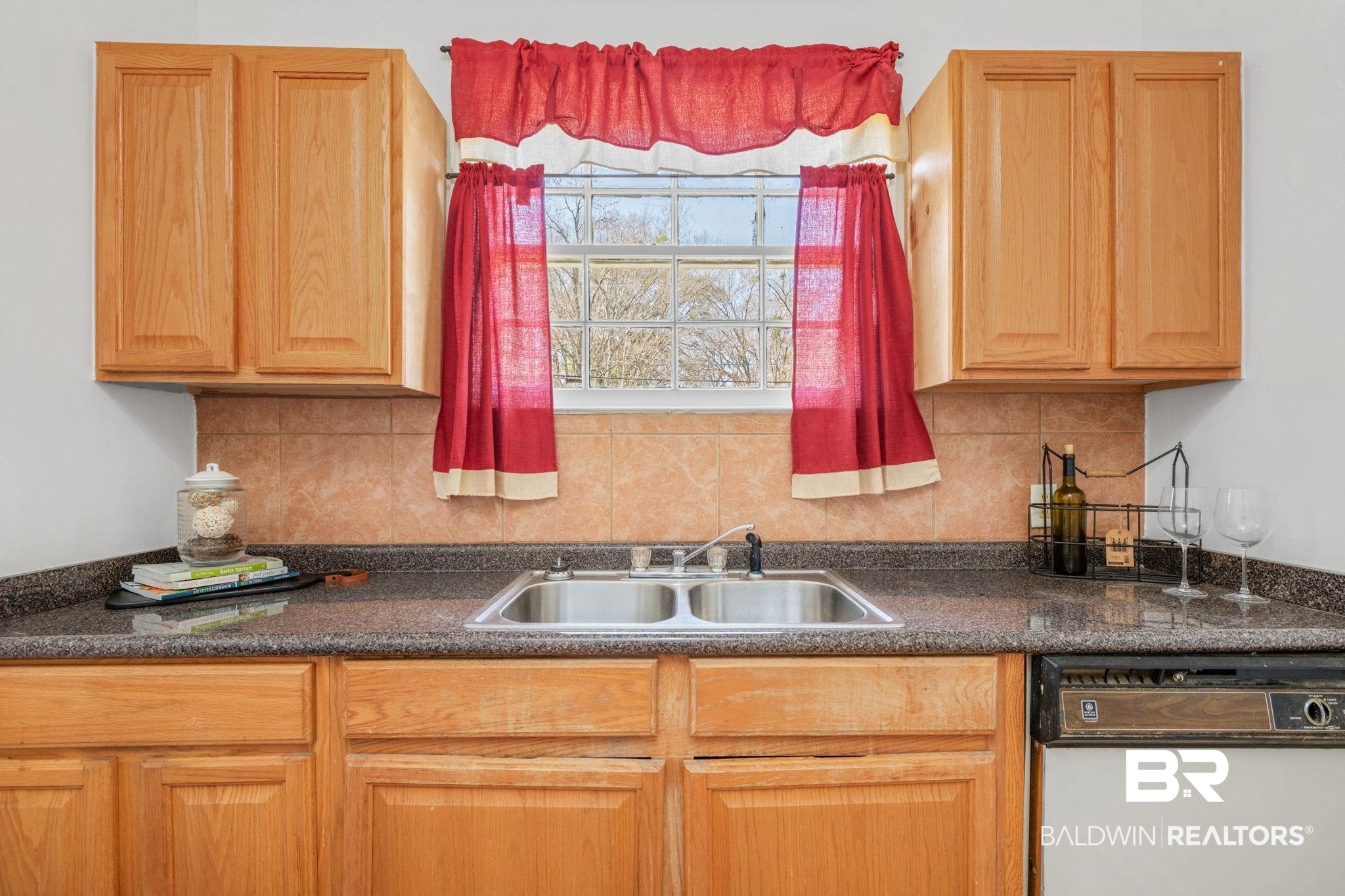 1707 Church Street Mobile, AL 36604 - Photo 7 of 43 Kitchen with dishwasher, dark countertops, backsplash, and a sink