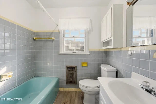 a bathroom with a sink a toilet and bathtub