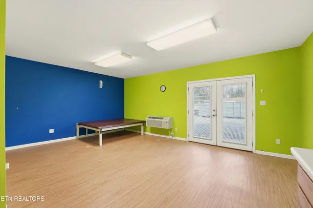 a view of room with furniture and wooden floor