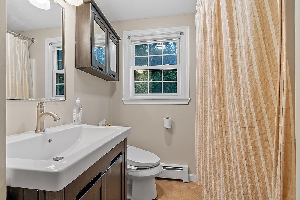 77 Hunt Road Chelmsford, MA 01824 - Photo 18 of 36 a bathroom with a sink a toilet and a mirror