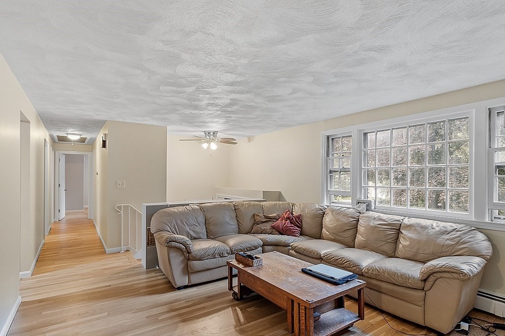 77 Hunt Road Chelmsford, MA 01824 - Photo 3 of 36 a living room with furniture a large window and a rug