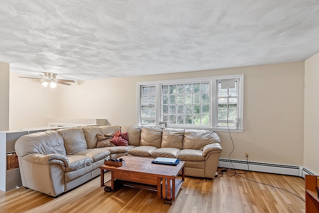 77 Hunt Road Chelmsford, MA 01824 - Photo 4 of 36 a living room with furniture and a window