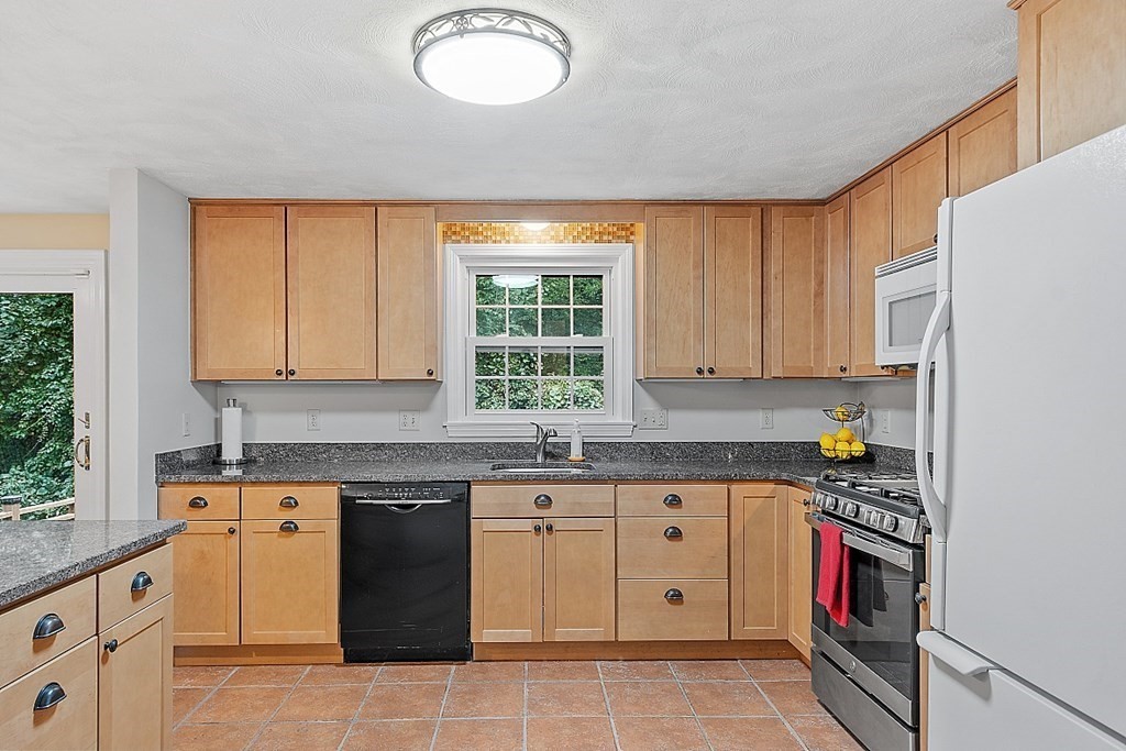 77 Hunt Road Chelmsford, MA 01824 - Photo 5 of 36 a kitchen with stainless steel appliances granite countertop a stove a sink and a microwave