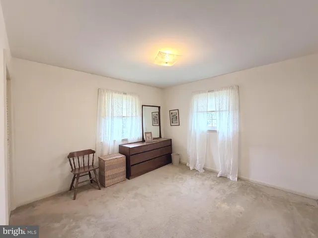 a bedroom with two beds and a lamp