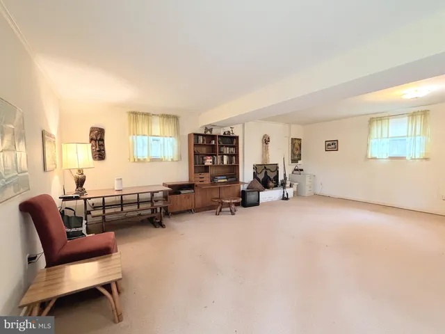 a view of a livingroom with workspace and a couch