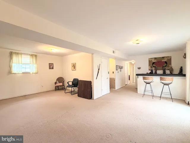 a view of a livingroom with furniture and a window