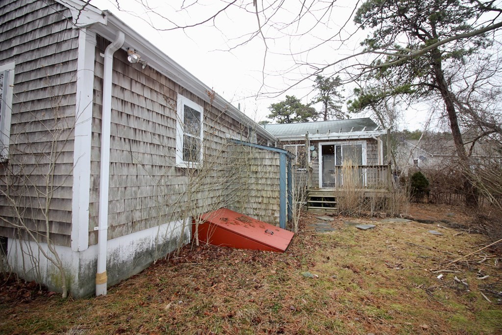 4 Thach Lane Barnstable, MA 02601 - Photo 15 of 18 a view of a house with a yard and wooden fence