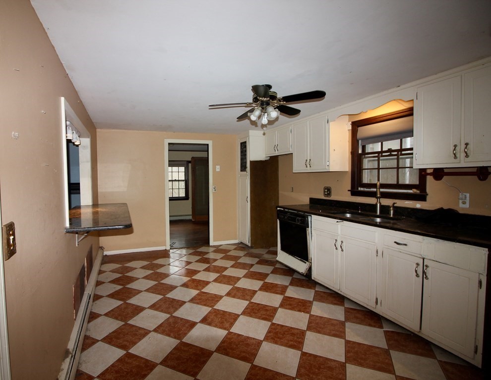 4 Thach Lane Barnstable, MA 02601 - Photo 4 of 18 a kitchen with granite countertop sink and a black white checkered floor