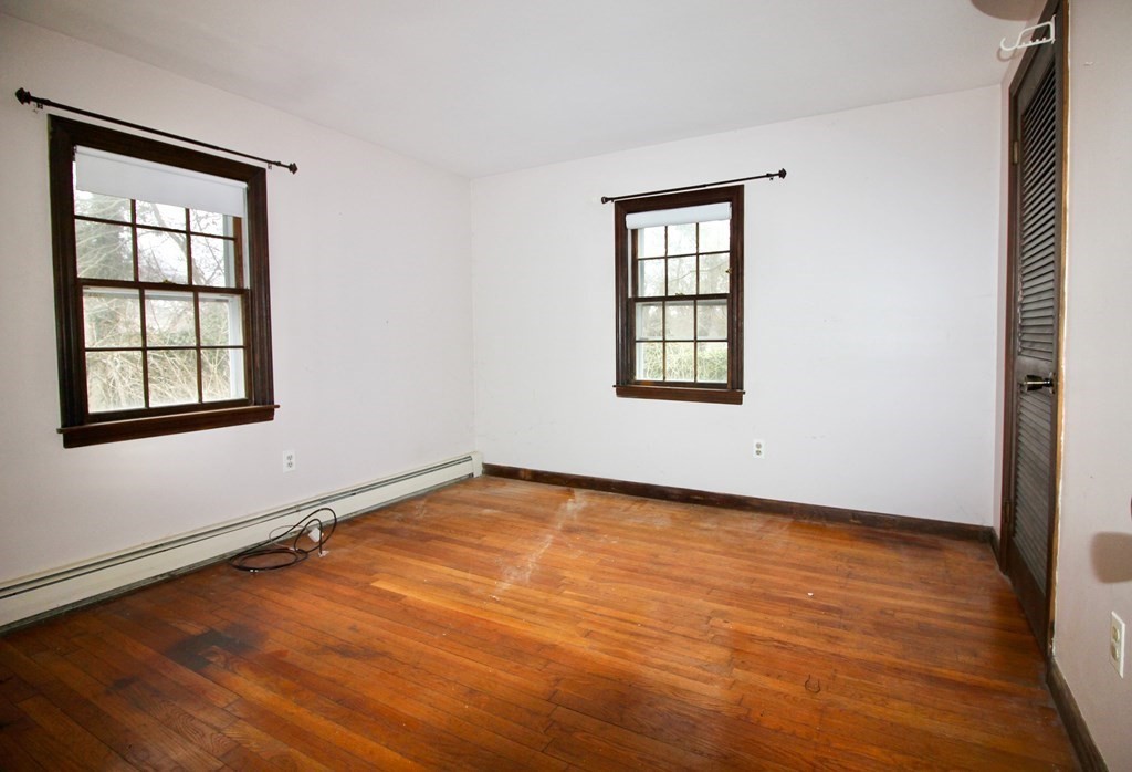 4 Thach Lane Barnstable, MA 02601 - Photo 7 of 18 an empty room with wooden floor and windows