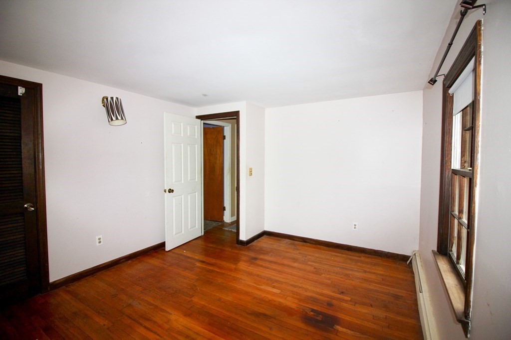 4 Thach Lane Barnstable, MA 02601 - Photo 8 of 18 an empty room with wooden floor and a window