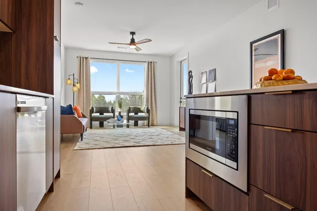 a kitchen with stainless steel appliances granite countertop a refrigerator a stove a sink and a refrigerator