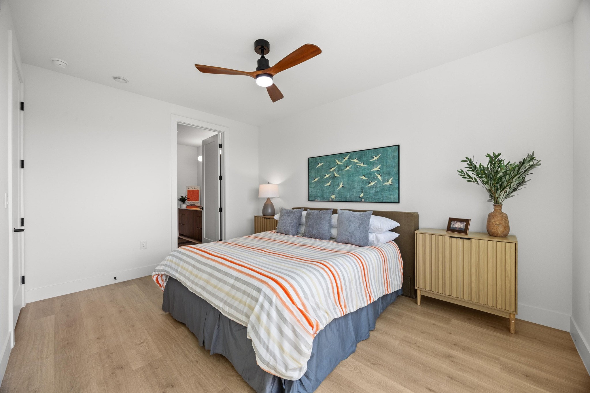 1701 Simond Avenue, Unit 223 Austin, TX 78723 - Photo 17 of 40 a bedroom with a large bed and a chandelier