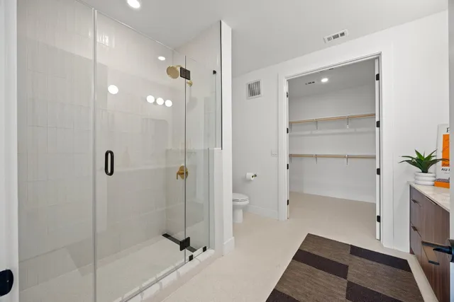 a bathroom with a shower and a glass door