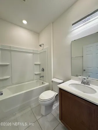 a bathroom with a double vanity sink and mirror