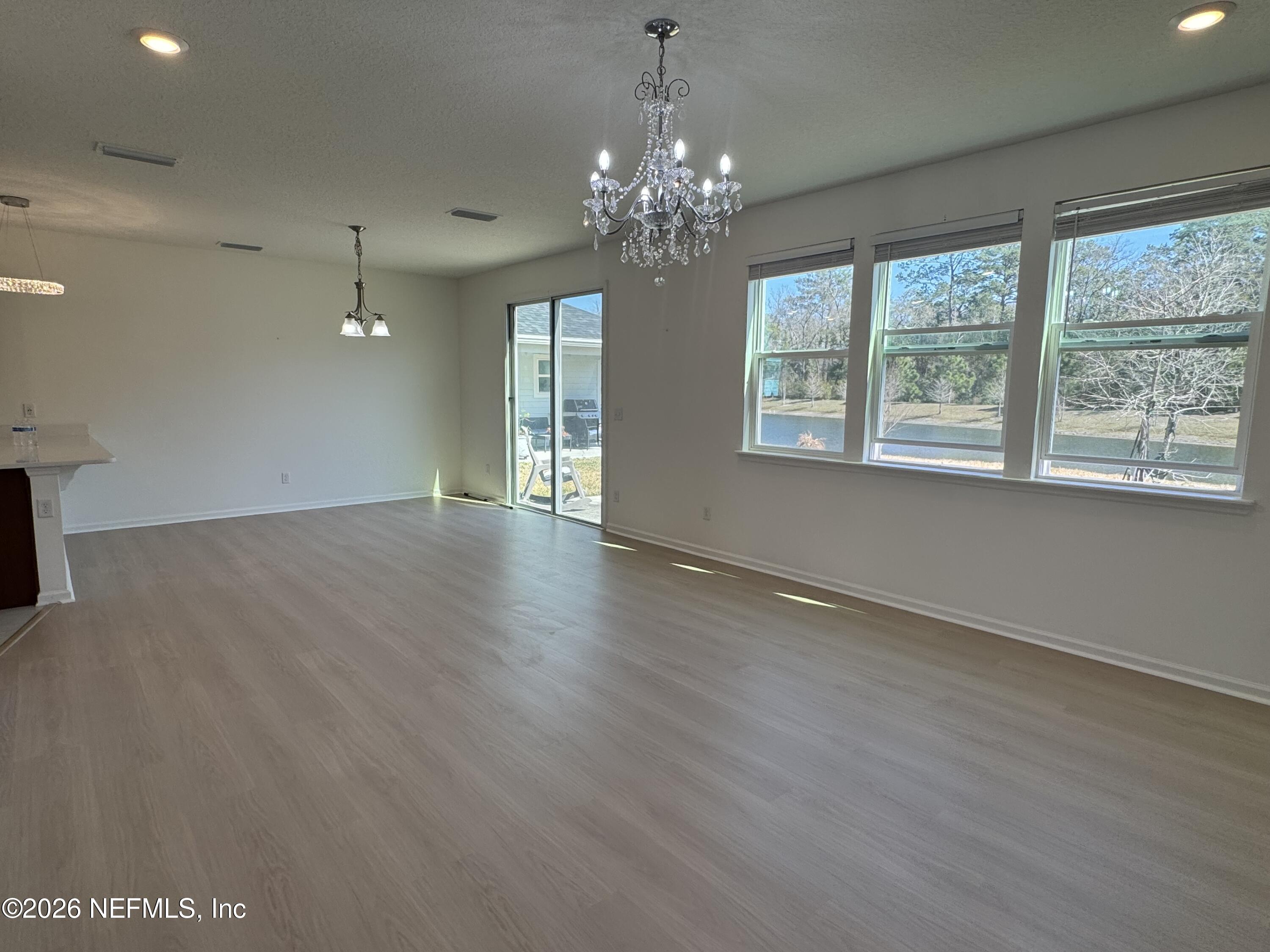 310 Rambling Brk Trail St. Johns, FL 32259 - Photo 7 of 28 a view of an empty room with wooden floor and a window