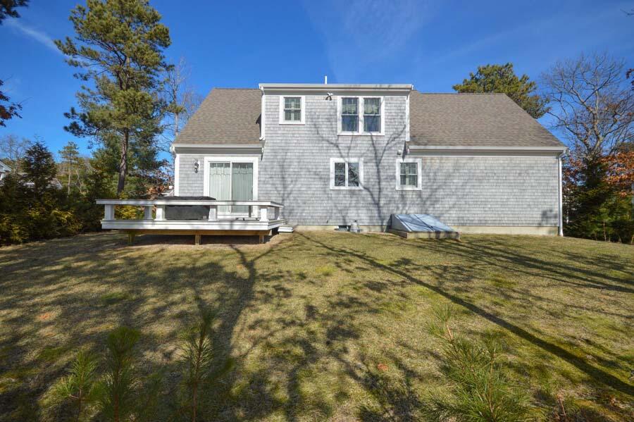 21 Dovetail Lane Cotuit, MA 02635 - Photo 21 of 30 a front view of a house with a yard