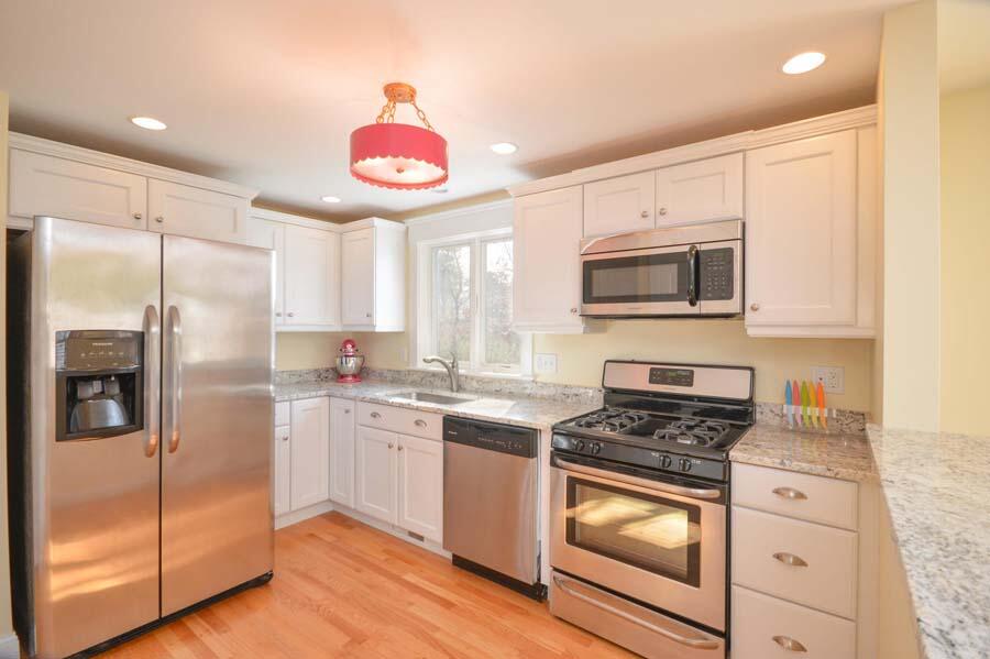 21 Dovetail Lane Cotuit, MA 02635 - Photo 3 of 30 a kitchen with stainless steel appliances granite countertop a stove a sink and a refrigerator