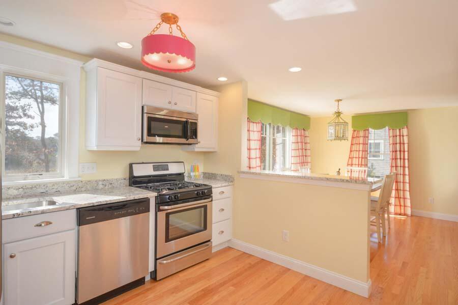 21 Dovetail Lane Cotuit, MA 02635 - Photo 5 of 30 a kitchen with granite countertop stainless steel appliances a stove cabinets and a window