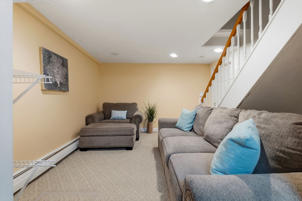 542 Trapelo Road Waltham, MA 02452 - Photo 31 of 40 a living room with furniture and a stairs