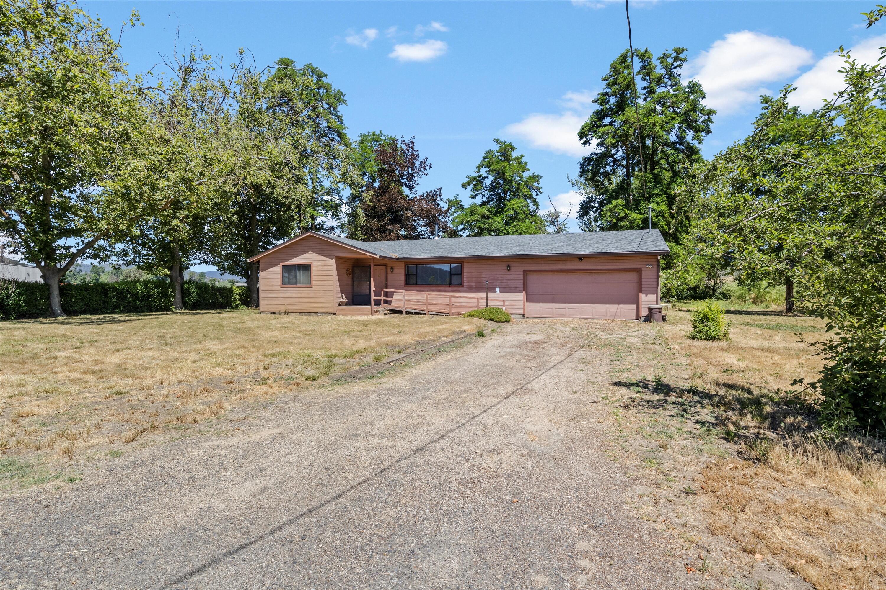 2908 Willow Springs Road Central Point, OR 97502 - Photo 8 of 34 a house with trees in the background