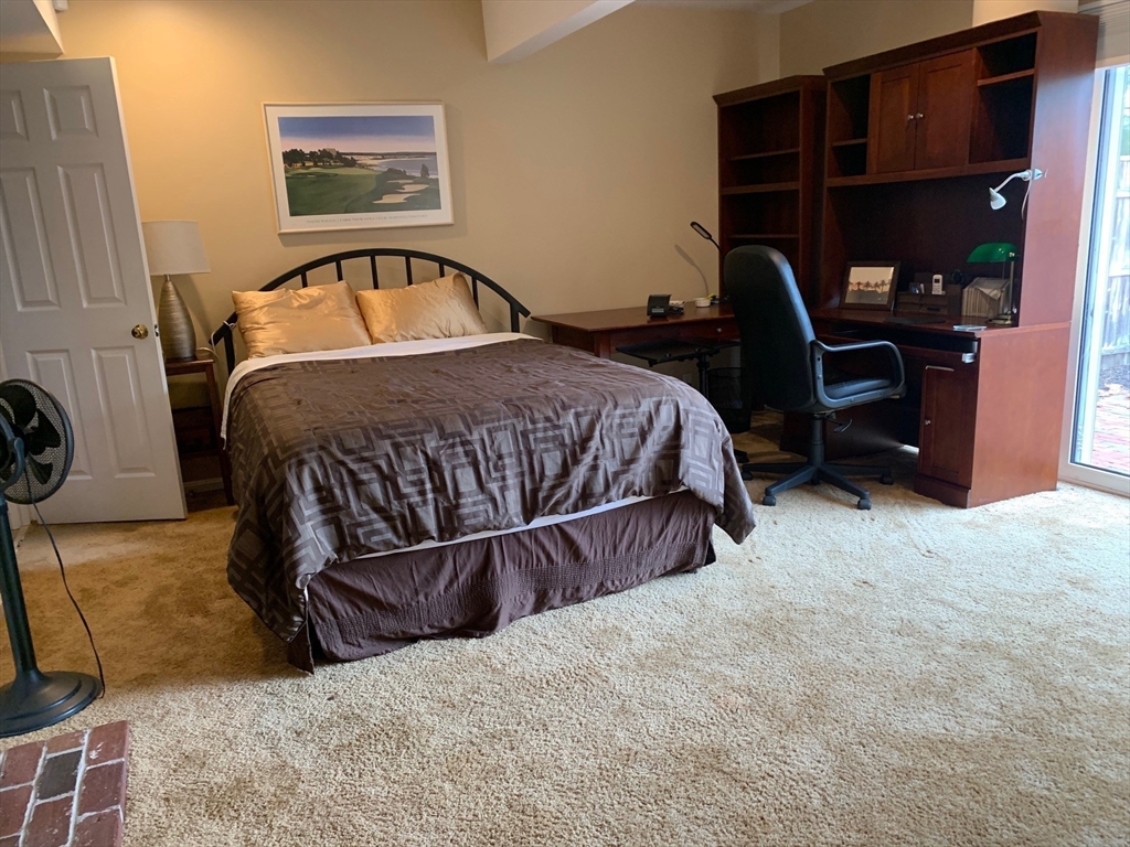 4 Potter Pond, Unit 4 Lexington, MA 02421 - Photo 12 of 15 a bedroom with a bed and cabinets