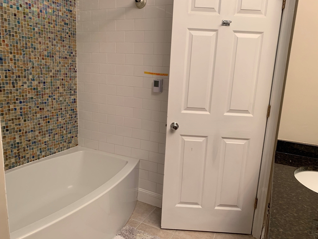 4 Potter Pond, Unit 4 Lexington, MA 02421 - Photo 15 of 15 a bathroom with a bathtub