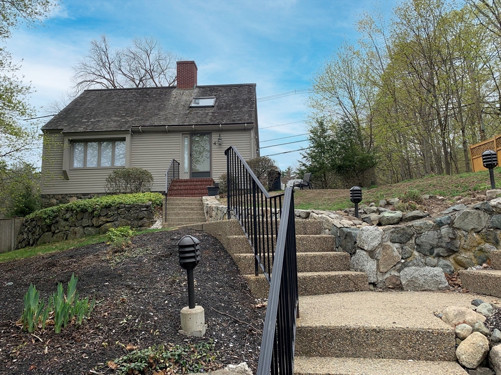 4 Potter Pond, Unit 4 Lexington, MA 02421 - Photo 2 of 15 a front view of a house with garden