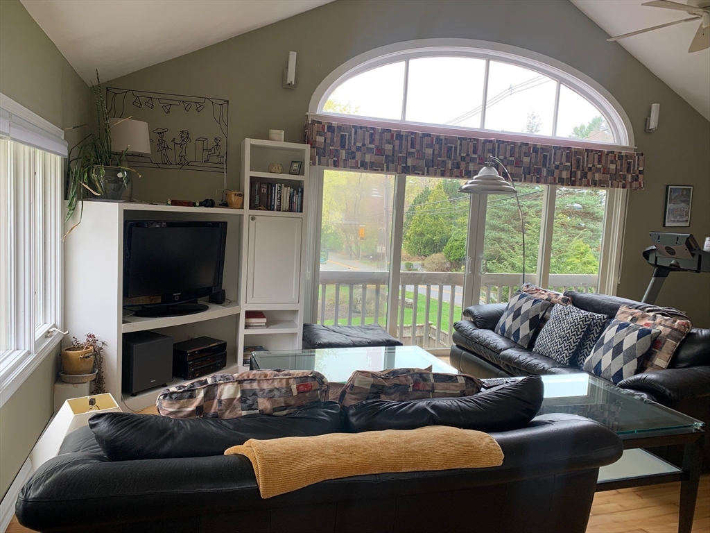 4 Potter Pond, Unit 4 Lexington, MA 02421 - Photo 3 of 15 a living room with furniture tv and a large window